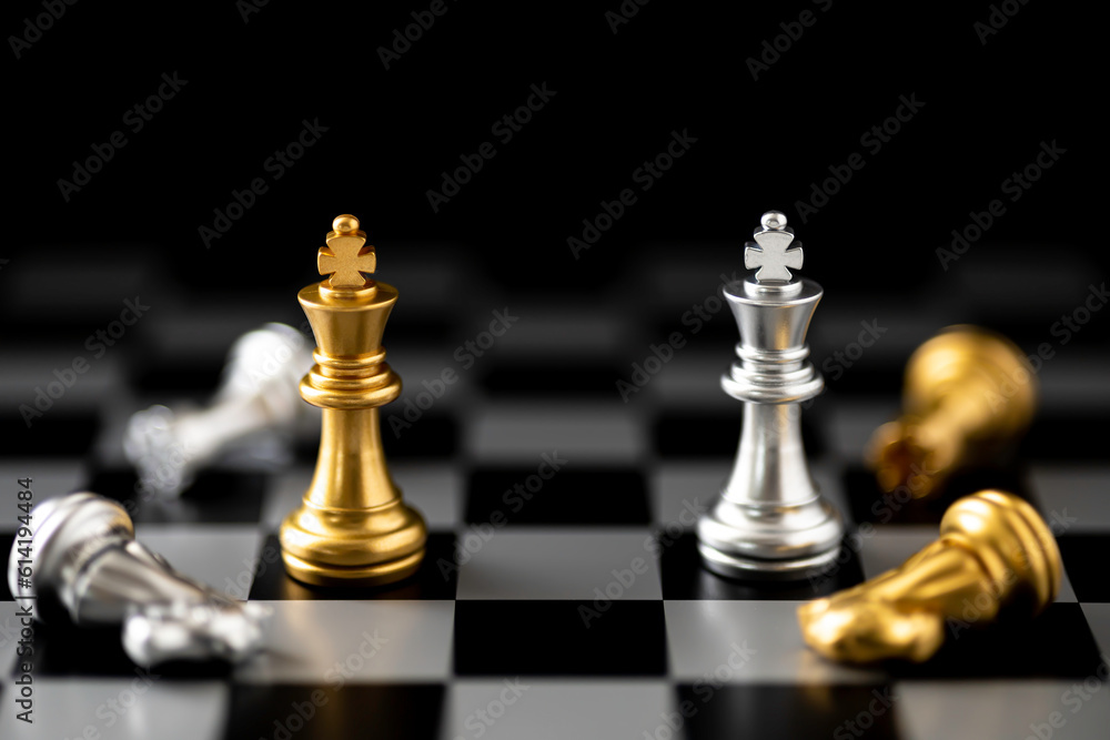 Golden and Silver King chess standing in front of other chess on chess board. Golden and Silver King chess standing in front of other chess on chess board.