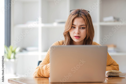 Asian women are bored from their online studies, have a sad face and have been tired from their studies for a long time.