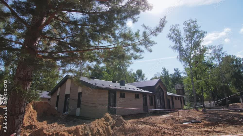 Sports base office with caution tapes at camp construction site in pine forest. Recreational resort center for tourists in wild wood Sports base office with caution tapes at camp construction site in pine forest. Recreational resort center for tourists in wild wood
