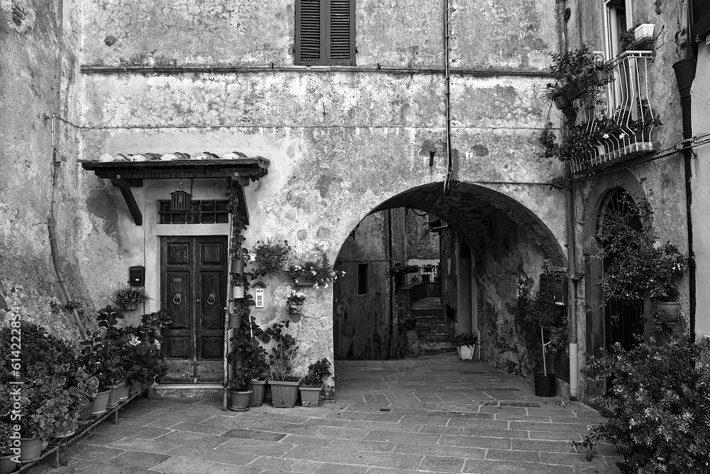 Stone houses on a paved street in a small town in Tuscany, Italy Stone houses on a paved street in a small town in Tuscany, Italy