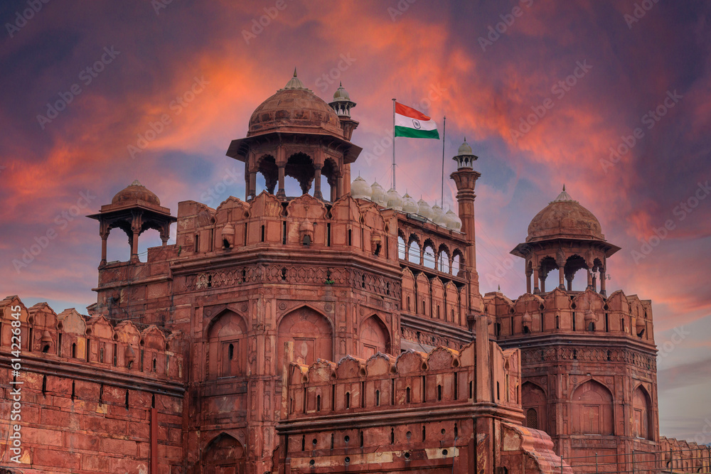 Red Fort or Lal Qila in Delhi with indian flag on foreground with moody sk.UNESCO World heritage site. Discover the India. Open world after covid-19
