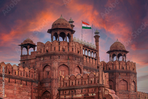 Obraz na płótnie Red Fort or Lal Qila in Delhi with indian flag on foreground with moody sk.UNESCO World heritage site. Discover the India. Open world after covid-19 w salonie