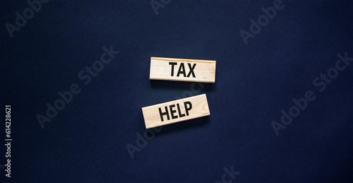 Tax help symbol. Concept words Tax help on wooden blocks on a beautiful black table black background. Business, support and tax help concept. Copy space.