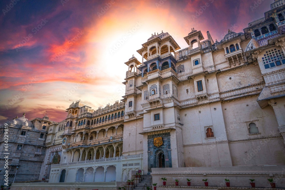 Romantic and luxury City Palace of Maharajah in Udaipur on Lake Pichola at sunset. Rajasthan, Discover the beauty of India. Open world after covid-19