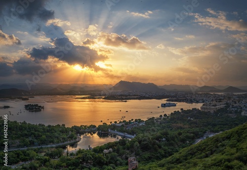 Aerial panoramic view of Udaipur, Lake palace, Lake Pichola at beautiful sunset and moody sky. Rajasthan, Discover the beauty of India. Open world after covid-19