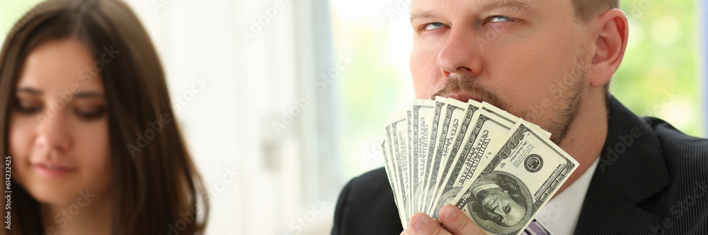 Man holds up dollars banknotes and enjoys success of financial income and growth. Emotion high from money concept Man holds up dollars banknotes and enjoys success of financial income and growth. Emotion high from money concept