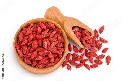 Dried goji berries in wooden bowl and scoop isolated on white background. Top view. Flat lay. photo