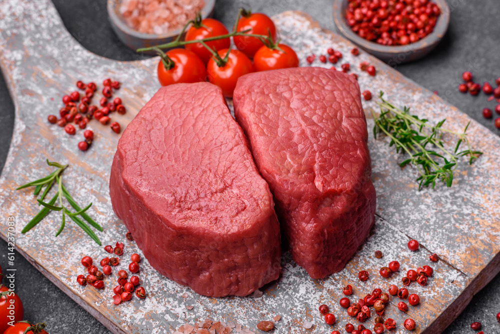 Raw beef eye steak round with salt, spices and herbs Raw beef eye steak round with salt, spices and herbs