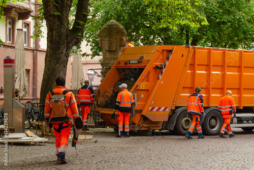 Rubbish collection in the city by street cleaners with a rubbish truck.