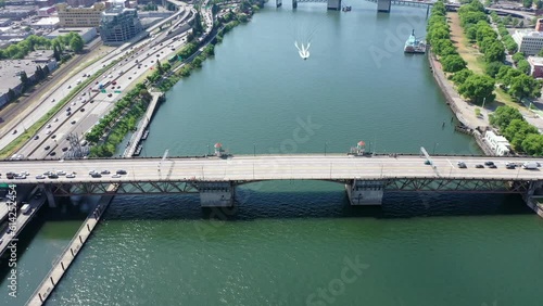 Portland Oregon, USA - June 28 23, steady flight above Willamette River with closed double-leafs bascule Burnside Bridge  - traffic is waiting before the start crossing the bridge, aerial footage