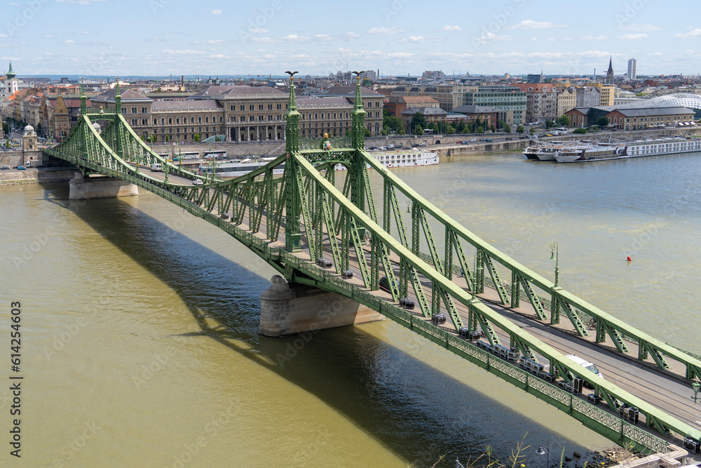 Liberty bridge or Freedom bridge over the Danube river. The Corvinus University is in the background. Budapest, Hungary