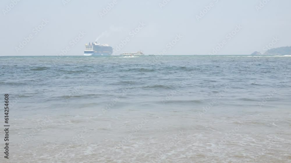 view to the ocean sea with passenger cruise ship tendering in the ocean under sunny sunshine daytime. Tourist cruise ship at tropical sea of Phuket view to the ocean sea with passenger cruise ship tendering in the ocean under sunny sunshine daytime. Tourist cruise ship at tropical sea of Phuket