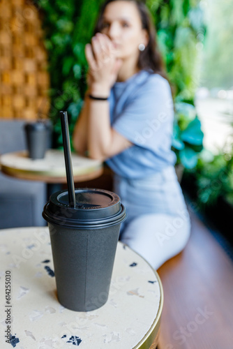 Portrait of beautiful woman having cup of coffee in cafe