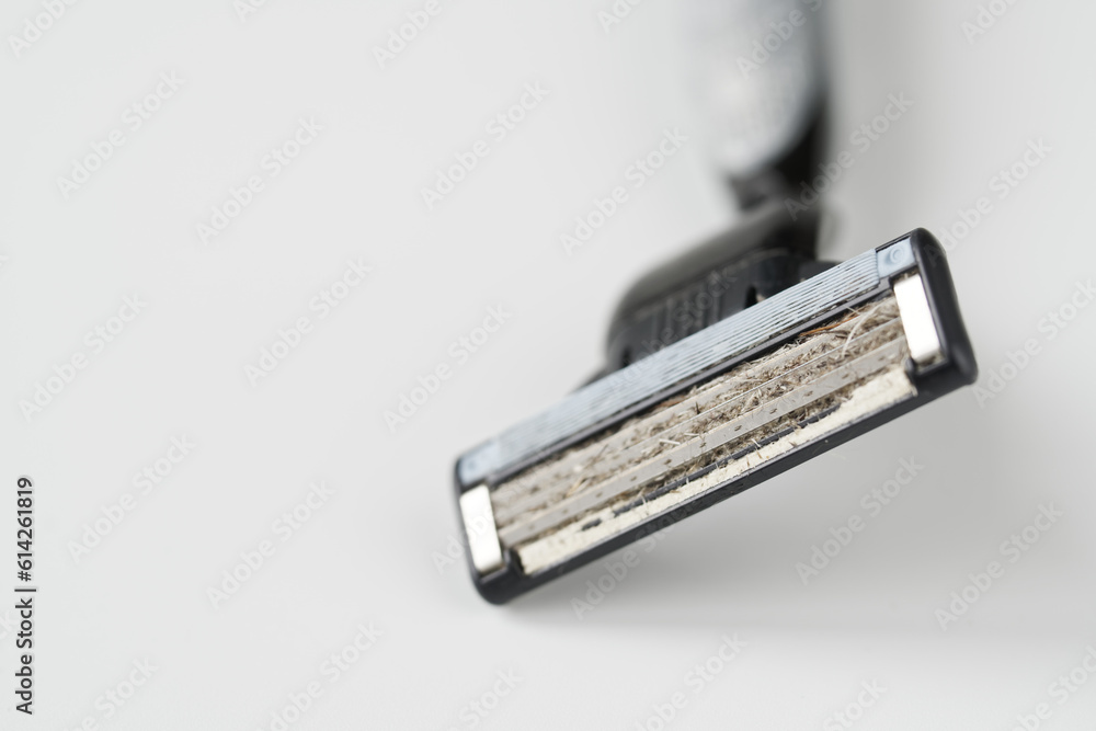 Dirty blade of a used razor. Unsanitary conditions, lack of hygiene and risk of infection. Macro. White background. Selective focus. Photo. Dirty blade of a used razor. Unsanitary conditions, lack of hygiene and risk of infection. Macro. White background. Selective focus. Photo.