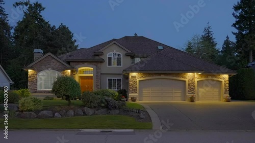 Wallpaper Mural Establishing shot of two story stucco luxury house with garage door, big tree and nice landscape at night in Vancouver, Canada, North America. Night time on Apr 2023. ProRes 422 HQ. Torontodigital.ca
