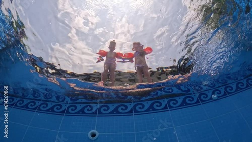 triplet sisters kids jumping in swiming pool