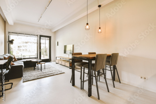 a living room with couches  chairs and a table in front of a sliding glass door that leads to the patio