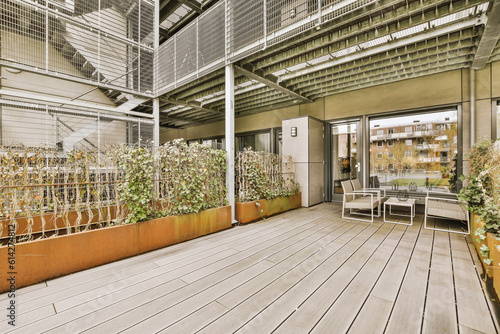 an outdoor patio area with plants and potted pots on the floor in front of the building s balcony