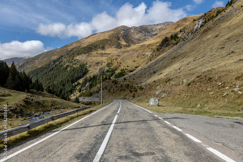 A mountain road leads towards the horizon with road marking. Transfagarash - the most beautiful and dangerous road in Europe