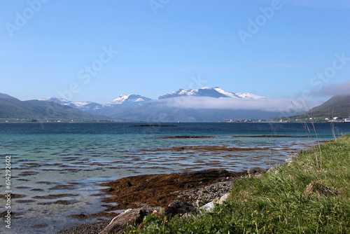 Sea lagoon with a view of the snow-capped mountains in the North of Norway, the Arctic