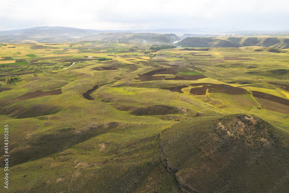 Green plateau with small volcanoes and calders during spring