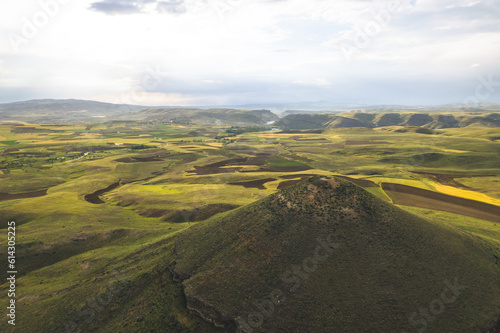 Green plateau with small volcanoes and calders during spring