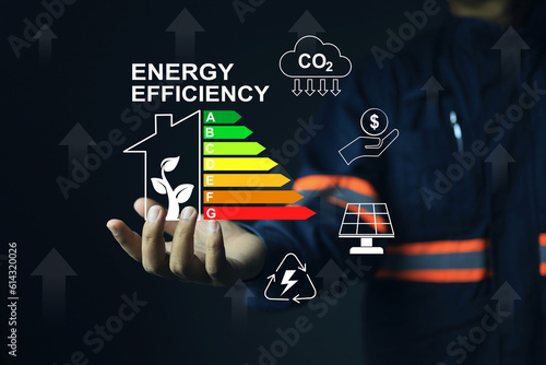 Obraz na plátne Staff or auditor working with home's energy efficiency rating label, which reflects the energy efficiency of residential home and the decision to buy it as a value