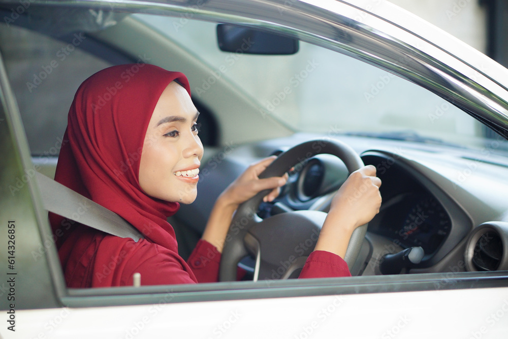 Beautiful businesswoman with hijab is smiling in her car Beautiful businesswoman with hijab is smiling in her car