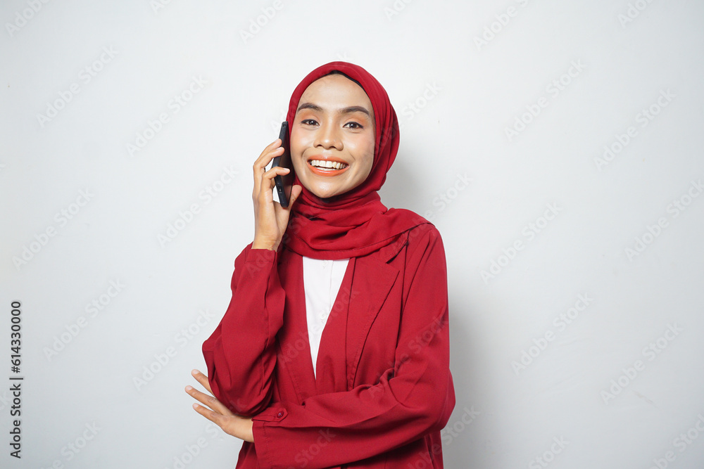 Asian Muslim businesswoman in red casual make a call isolated by a white background Asian Muslim businesswoman in red casual make a call isolated by a white background