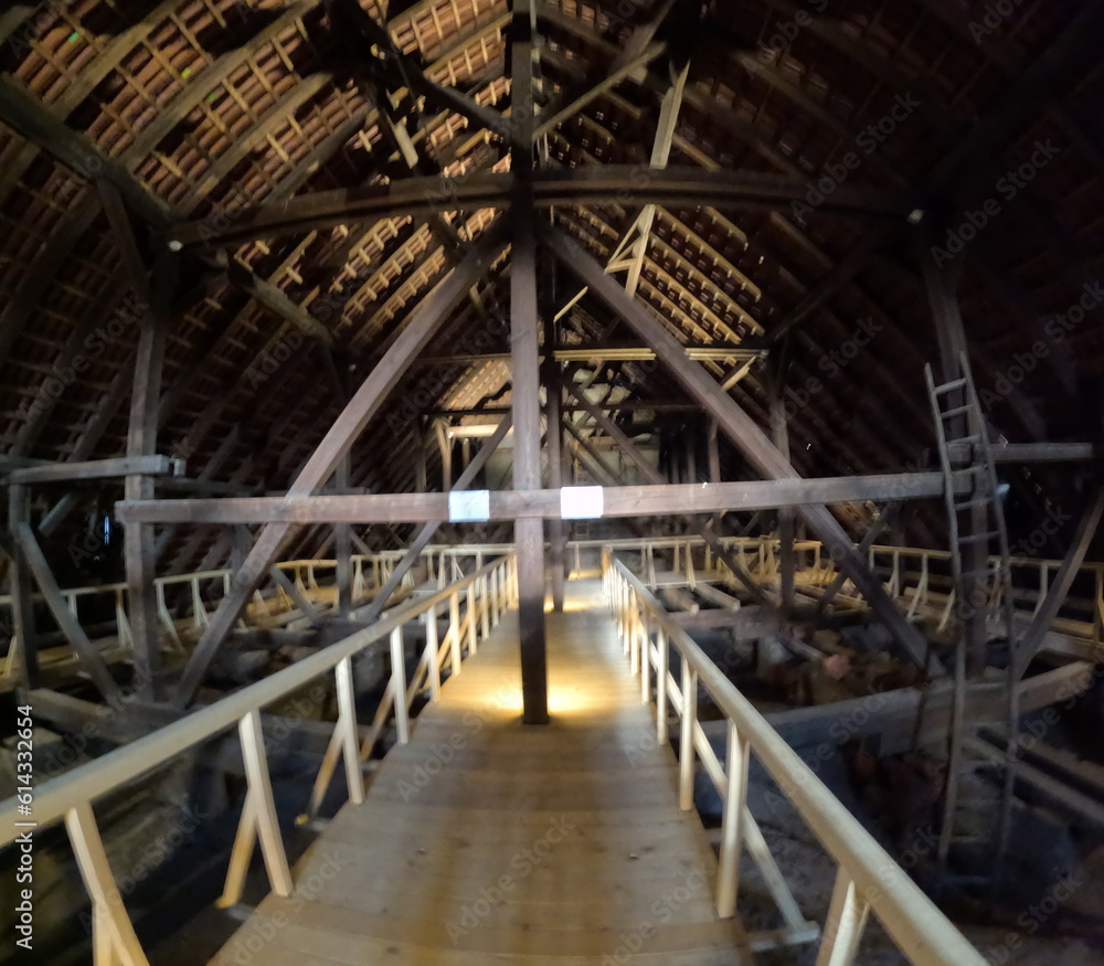 Fototapeta premium Wooden trusses supporting the roof of an old Gothic church, showcasing medieval engineering, craftsmanship, and the architectural ingenuity of historical Europe.