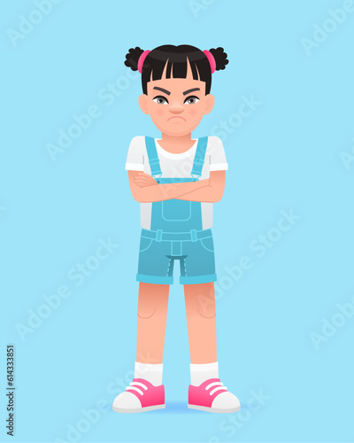 A disgruntled little girl stands with her arms crossed. A beautiful cute white baby in a blue summer jumpsuit.