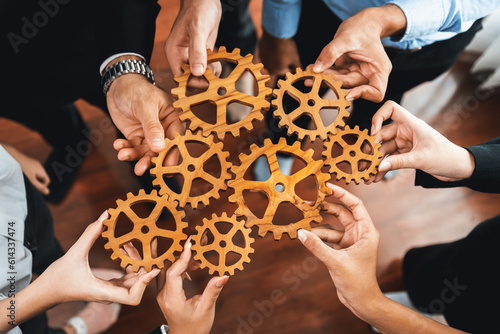 Slika na platnu Group of multiracial business people joining gear wheels together as effective unity and productive teamwork concept
