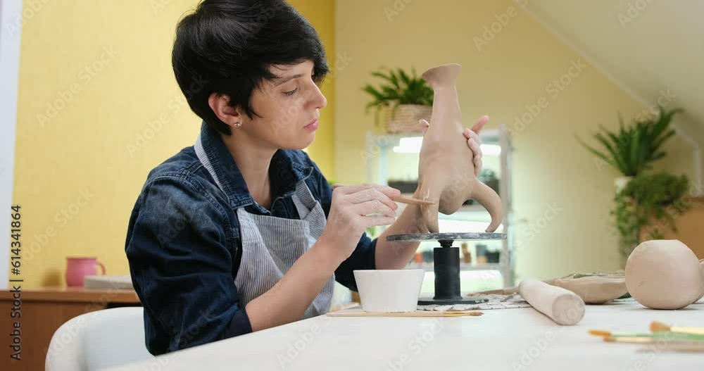 woman sculpts vase from clay by hands, closeup in artistic studio woman sculpts vase from clay by hands, closeup in artistic studio