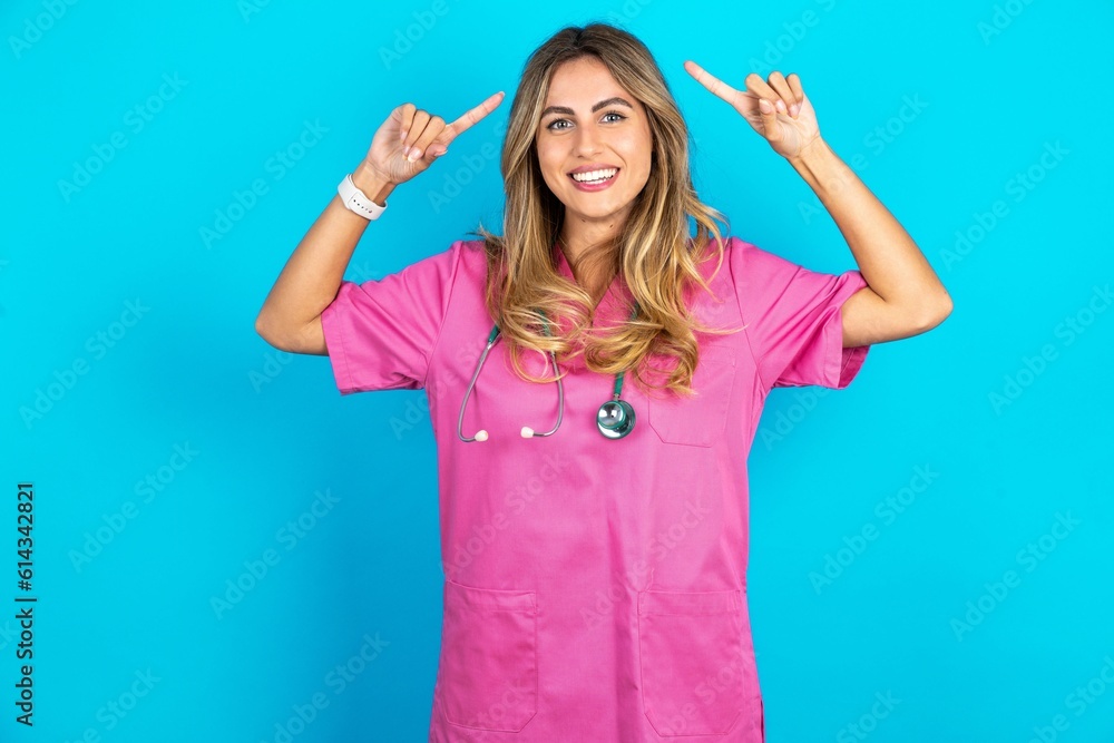 Photo of crazy Young caucasian blonde woman wearing pink uniform screaming and pointing with fingers at hair closed eyes Photo of crazy Young caucasian blonde woman wearing pink uniform screaming and pointing with fingers at hair closed eyes