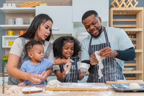 african afro black daughter kids with dad father and mom happy family funny for teach cooking. Black african daughter afro hair and son enjoy with dad preparing the dough, bake cookies in the kitchen