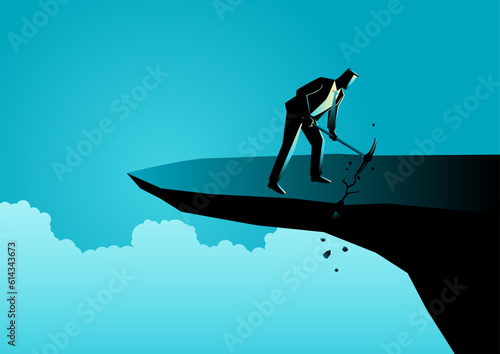 Businessman with a pick axe digs the edge of a rock to cause himself to fall, wrong strategy, stupidity concept