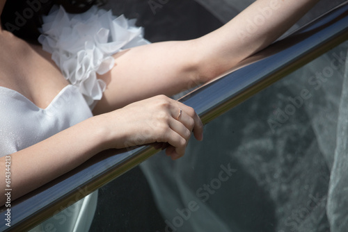 bride's hand on the railing, closeup of photo.