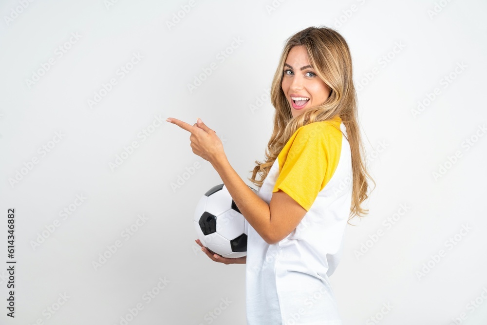 Profile photo of Young beautiful woman wearing football T-shirt over white background indicate finger empty space offer Profile photo of Young beautiful woman wearing football T-shirt over white background indicate finger empty space offer