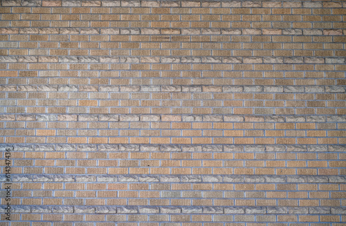 Textured Orange and Gray Brick Wall with Facade.