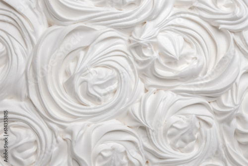 A delightful background featuring luscious swirls of whipped cream, adding a touch of sweetness and elegance to any design or culinary project.