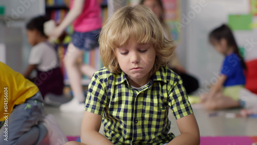 Wallpaper Mural Portrait of sad boy sitting alone in kindergarten playroom Torontodigital.ca