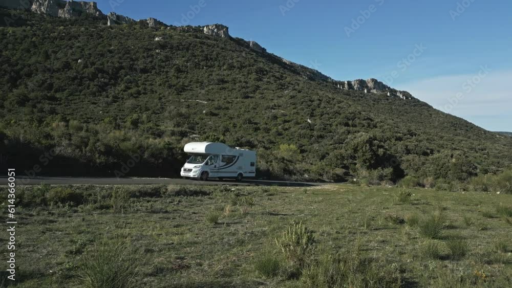 White Caravan Car Drives Uphill Green Mountains of South France, RV Motorhome in European Summer Landscape, Aerial Drone View White Caravan Car Drives Uphill Green Mountains of South France, RV Motorhome in European Summer Landscape, Aerial Drone View
