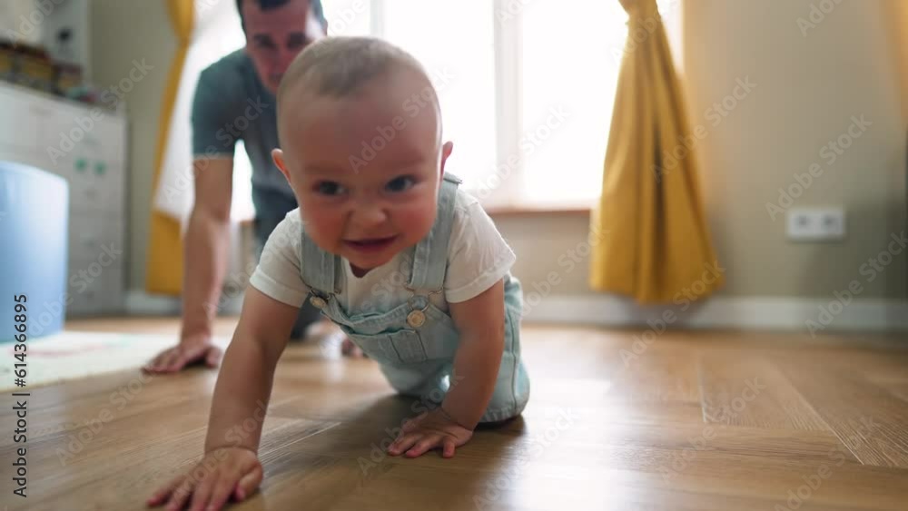 Baby first steps.Toddler at home takes funny first steps.Dad teaches child to walk, legs close-up.Toddler feet on laminate floor.Father's day child education.Kid dream study at home.walk baby learning Baby first steps.Toddler at home takes funny first steps.Dad teaches child to walk, legs close-up.Toddler feet on laminate floor.Father's day child education.Kid dream study at home.walk baby learning