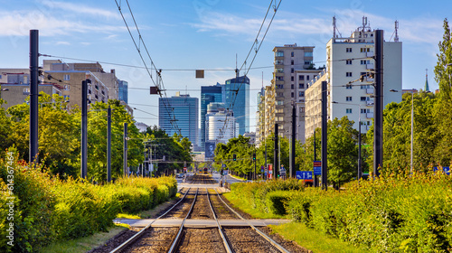 Wola and Srodmiescie downtown business districts panorama with skyscrapers along tram track at Aleja Jana Pawla II avenue in Warsaw in Poland