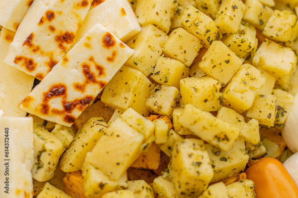 Cheese snacks in one container. Sliced cheese in different shapes. Cheese board for the celebration Cheese snacks in one container. Sliced cheese in different shapes. Cheese board for the celebration