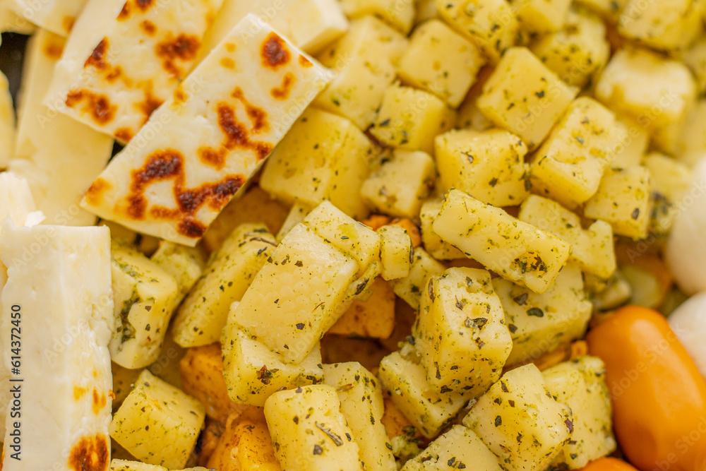Cheese snacks in one container. Sliced cheese in different shapes. Cheese board for the celebration Cheese snacks in one container. Sliced cheese in different shapes. Cheese board for the celebration