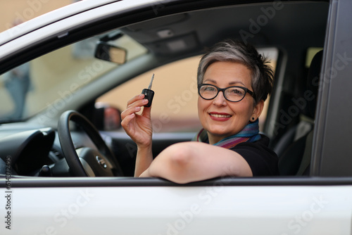 City car rental, happy female consumer with keys in her hands.