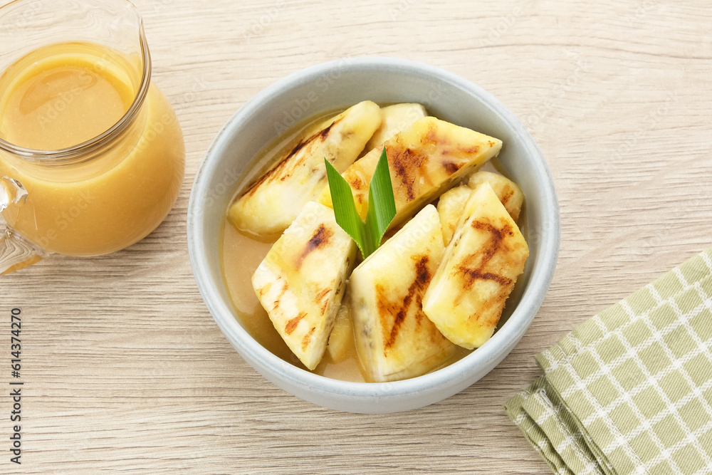 Pisang Gapit or Pisang Epe, grilled banana with palm sugar sauce. Indonesian traditional food.
Pisang Gapit or Pisang Epe, grilled banana with palm sugar sauce. Indonesian traditional food.