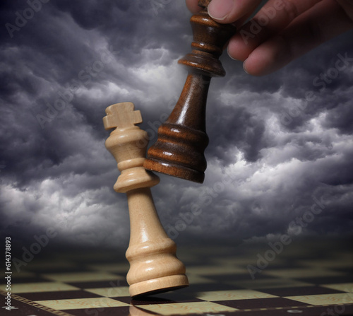 Hand holding a piece on a chessboard 