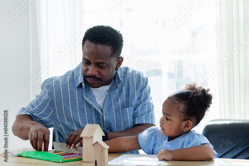 happy family african father and daughter Coloring together. Homeschool concept  happy family.